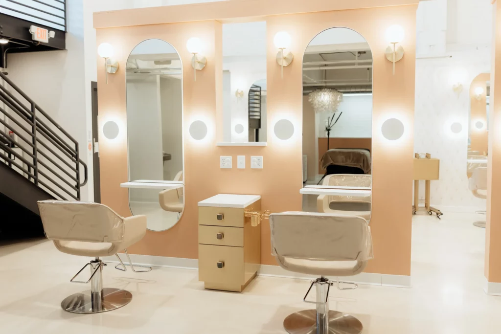 A view of the two hair stations on a peach colored wall.